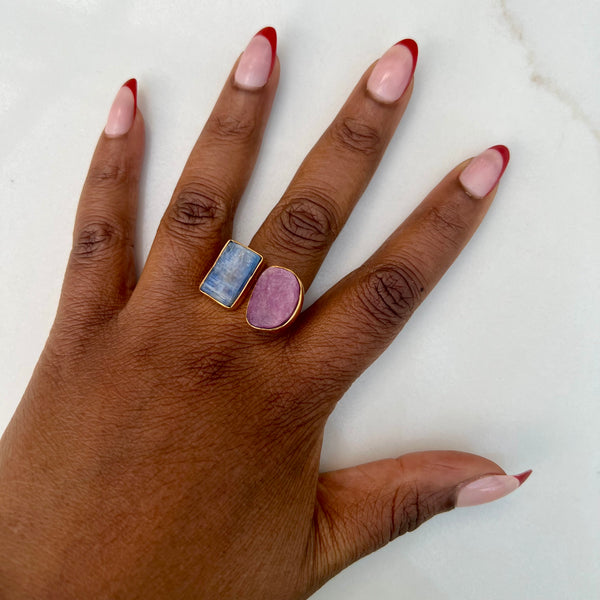 Hand model wearing natural kyanite and ruby 18k gold-plated brass ring. 